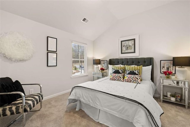 carpeted bedroom with lofted ceiling