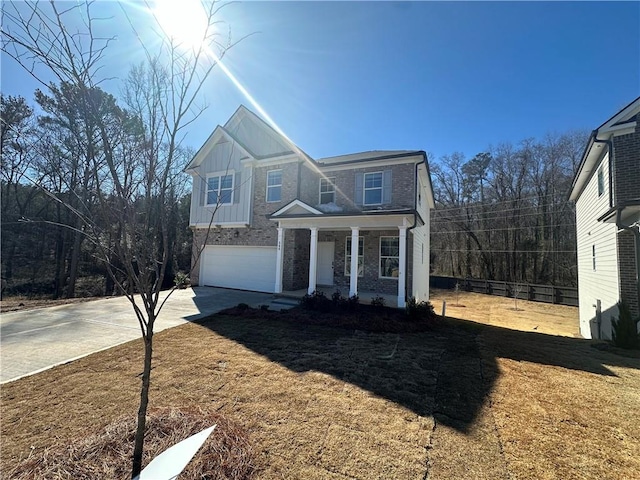 view of front of house with a garage, a porch, and a front yard