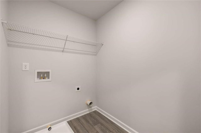 washroom with hardwood / wood-style floors, electric dryer hookup, washer hookup, and hookup for a gas dryer