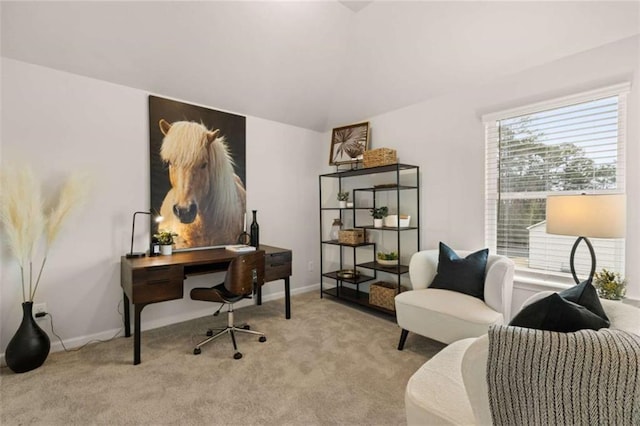 home office with light colored carpet and vaulted ceiling