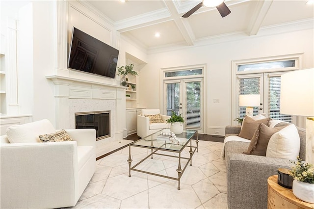 living area with built in shelves, french doors, and beamed ceiling