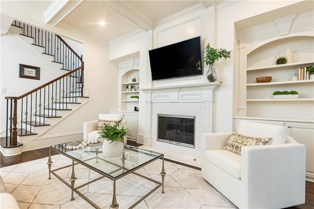 living room with coffered ceiling, ceiling fan, light wood-style flooring, beamed ceiling, and stairs