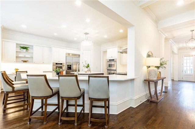 kitchen with pendant lighting, stainless steel appliances, a large island with sink, white cabinetry, and open shelves