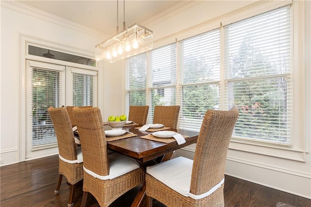 dining area with ornamental molding and dark wood-type flooring