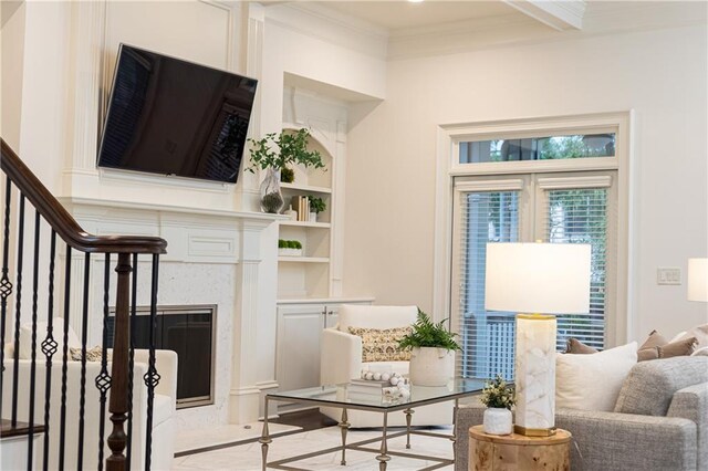 living area with light wood-style floors, baseboards, beam ceiling, and french doors