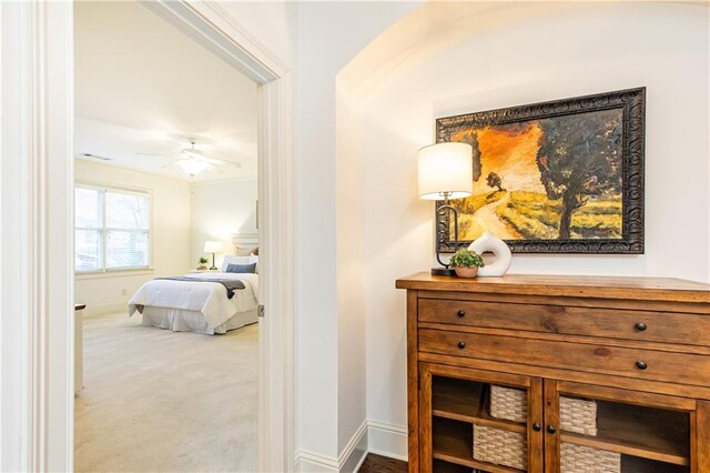 bedroom featuring multiple windows, visible vents, and ornamental molding