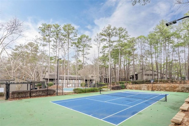 view of tennis court with fence