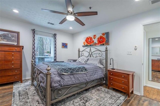 bedroom with visible vents, baseboards, and wood finished floors