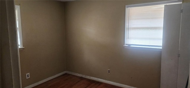 spare room with dark hardwood / wood-style floors