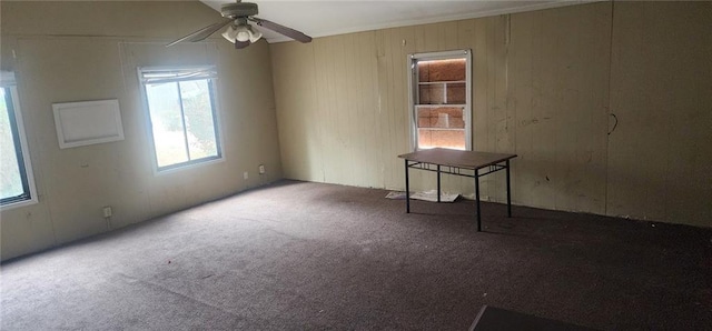 empty room with ceiling fan and carpet