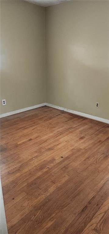 spare room with hardwood / wood-style flooring