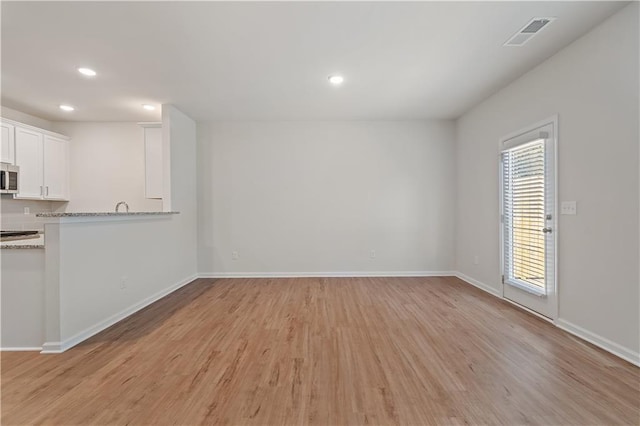 interior space featuring light wood-type flooring and a wealth of natural light