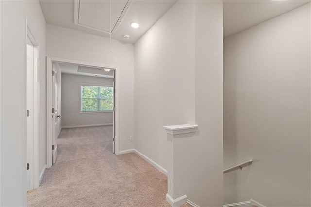 hallway featuring light colored carpet