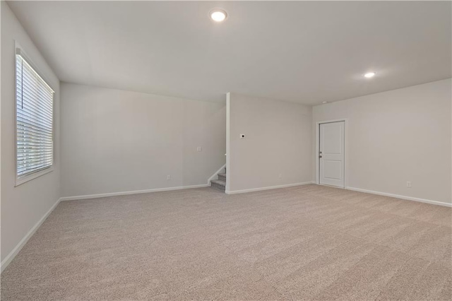 unfurnished room featuring light colored carpet