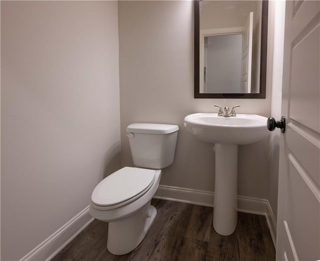 bathroom featuring sink, hardwood / wood-style floors, and toilet