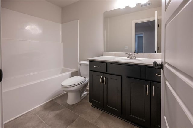 full bathroom featuring vanity, tile patterned floors, washtub / shower combination, and toilet