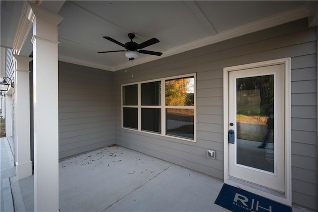 view of exterior entry featuring a patio area and ceiling fan