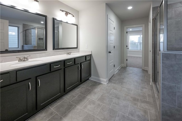 bathroom featuring vanity and an enclosed shower