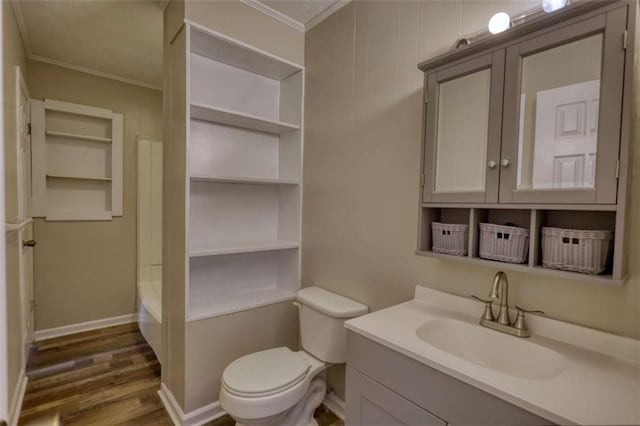 full bath with toilet, ornamental molding, wood finished floors, and vanity