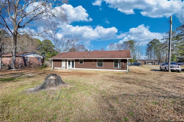 back of house featuring a lawn