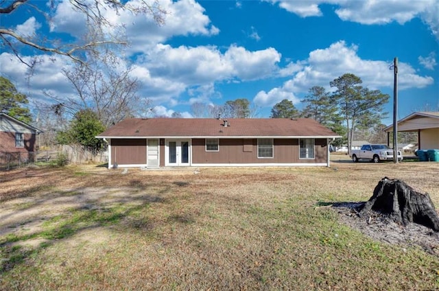 back of house featuring a lawn