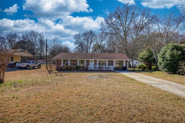 single story home featuring covered porch, driveway, and a front lawn