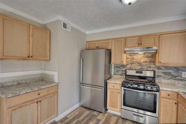 kitchen featuring wood finished floors, appliances with stainless steel finishes, light brown cabinets, and under cabinet range hood