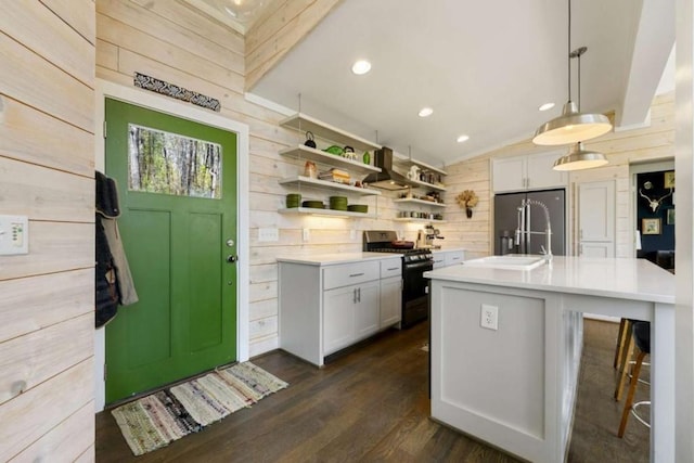 124 Nichols Branch Ln, Clayton, GA 30525 - kitchen featuring gas range oven, wood walls, light countertops, high quality fridge, and lofted ceiling