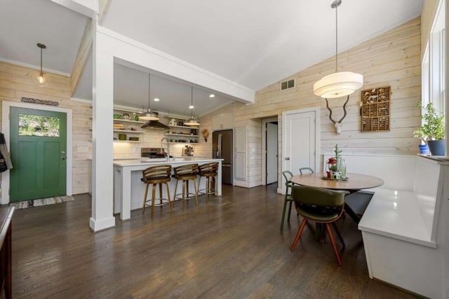 124 Nichols Branch Ln, Clayton, GA 30525 - dining space featuring wood walls, lofted ceiling, and dark wood finished floors