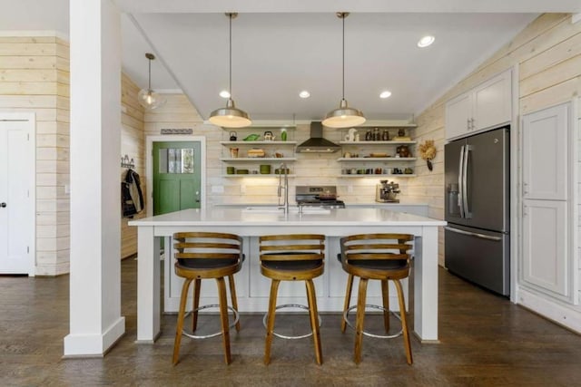 124 Nichols Branch Ln, Clayton, GA 30525 - kitchen featuring stainless steel appliances, open shelves, wall chimney range hood, wood walls, and light countertops