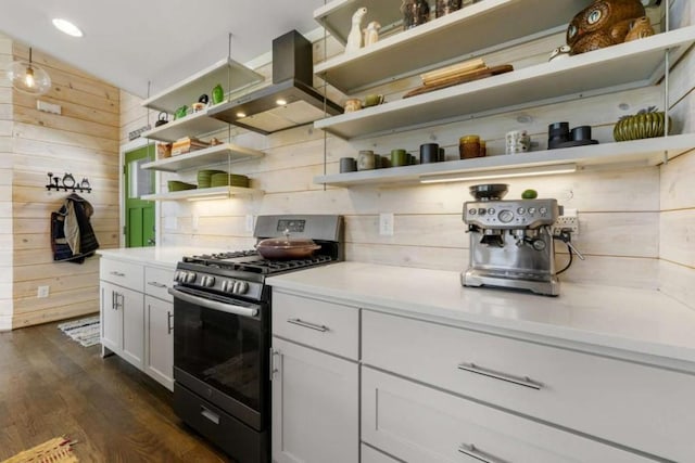 124 Nichols Branch Ln, Clayton, GA 30525 - kitchen with open shelves, gas range oven, island exhaust hood, wooden walls, and dark wood finished floors