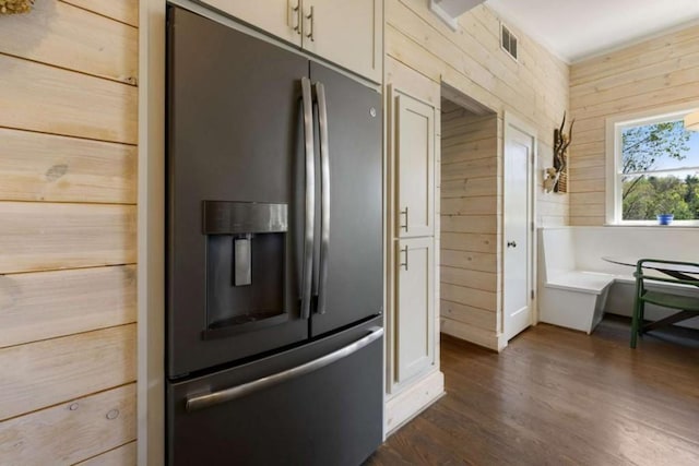 124 Nichols Branch Ln, Clayton, GA 30525 - kitchen with stainless steel fridge, dark wood-style floors, and wooden walls
