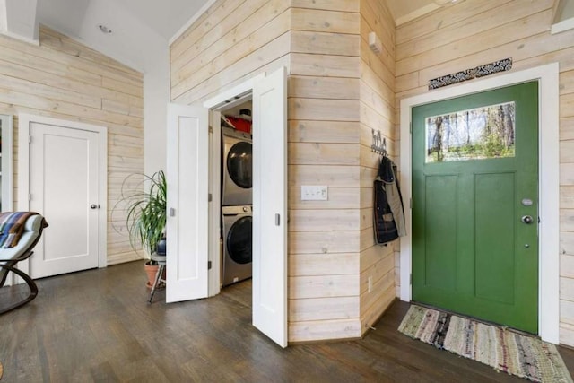 124 Nichols Branch Ln, Clayton, GA 30525 - entryway featuring wood walls, stacked washing machine and dryer, dark wood-type flooring, and high vaulted ceiling
