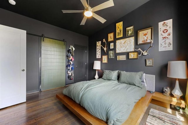 124 Nichols Branch Ln, Clayton, GA 30525 - bedroom with wood finished floors, baseboards, a ceiling fan, and a barn door
