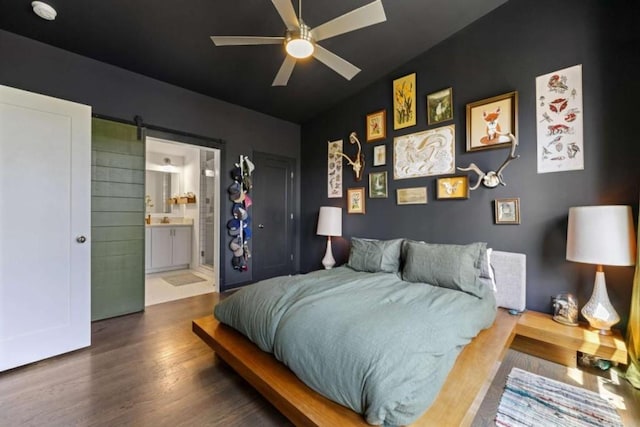 124 Nichols Branch Ln, Clayton, GA 30525 - bedroom with wood finished floors, a barn door, connected bathroom, and a ceiling fan