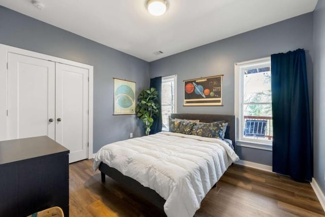 124 Nichols Branch Ln, Clayton, GA 30525 - bedroom with multiple windows, wood finished floors, and baseboards