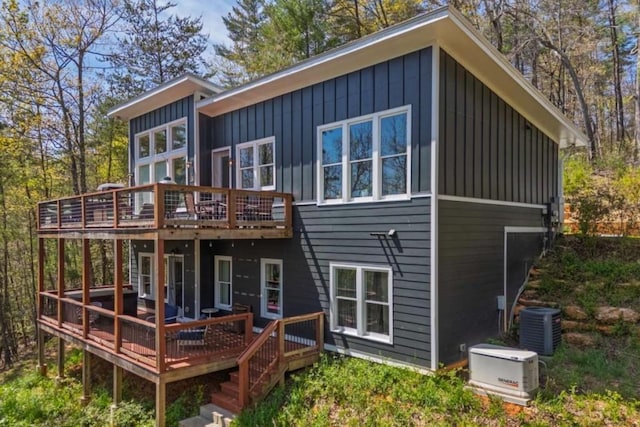 124 Nichols Branch Ln, Clayton, GA 30525 - back of property featuring board and batten siding, a deck, and central AC