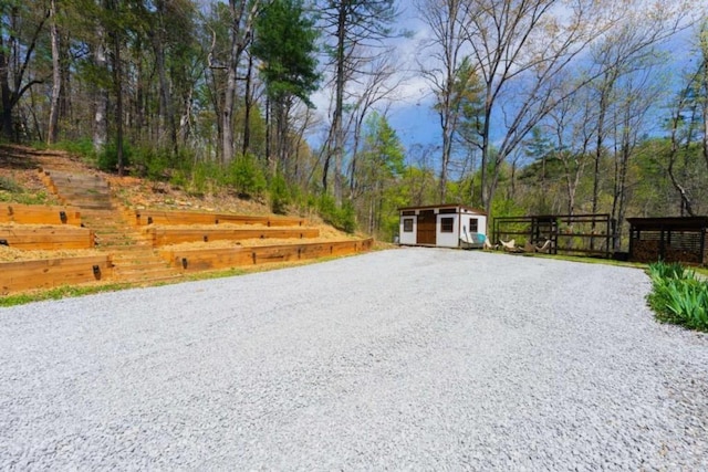 124 Nichols Branch Ln, Clayton, GA 30525 - view of yard with an outdoor structure, a storage shed, driveway, and fence