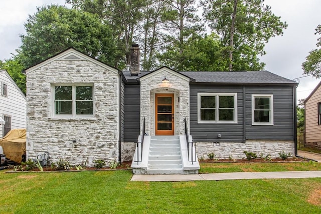 view of front of property with a front lawn and an outdoor structure