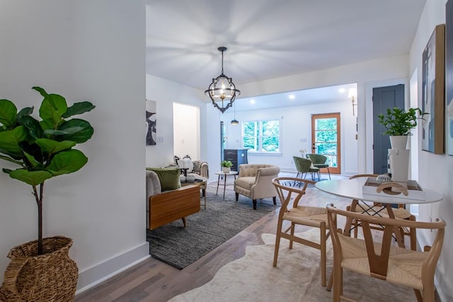 dining space with a chandelier and light hardwood / wood-style floors