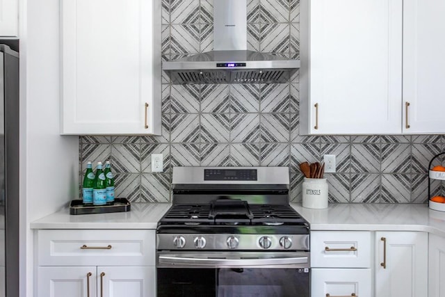 kitchen with white cabinets, backsplash, wall chimney exhaust hood, and gas stove