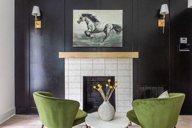 living area featuring a fireplace and wood-type flooring