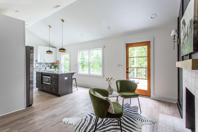 interior space featuring light hardwood / wood-style floors and vaulted ceiling