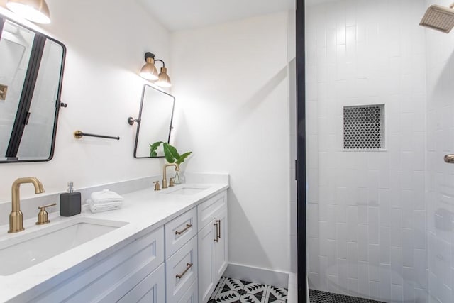 bathroom with dual vanity, tile floors, and tiled shower