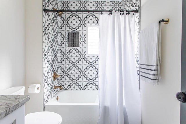 full bathroom featuring toilet, vanity, and shower / tub combo with curtain