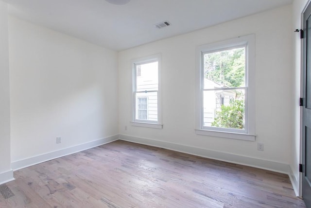 spare room featuring light wood-type flooring