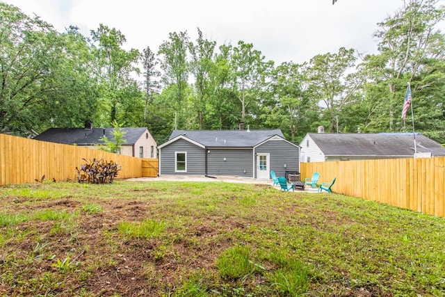 back of house featuring a lawn and a patio area