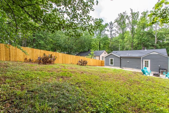 view of yard with a fire pit and a patio