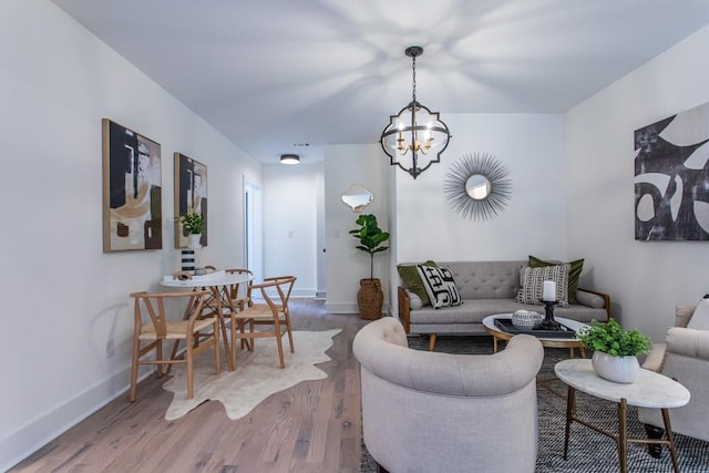 living room featuring a notable chandelier and hardwood / wood-style flooring