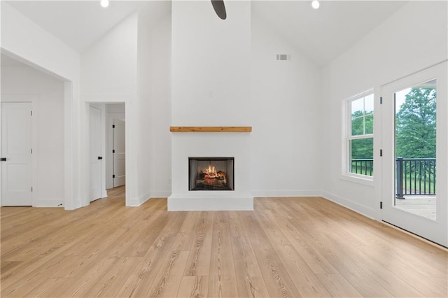 102-A S Cay Dr, Milledgeville, GA 31061 - unfurnished living room with high vaulted ceiling, a warm lit fireplace, light wood-style floors, baseboards, and ceiling fan